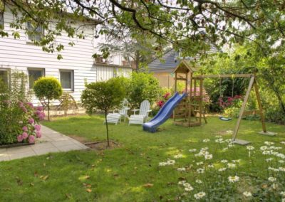 Garden with loungers, slide and swings